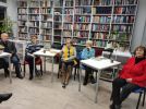 Zdjęcie przedstawia ludzi w bibliotece