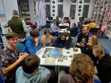 Zdjęcie przedstawia ludzi w bibliotece