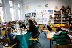 Zdjęcie przedstawia ludzi w bibliotece