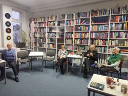 Zdjęcie przedstawia ludzi w bibliotece