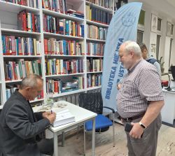 Zdjęcie przedstawia osoby podczas spotkania autorskiego z Wojciechem Jagielskim